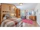 Bright bedroom featuring a lofted bed with workspace and a red geometrically patterned rug at 465 Holly Hill Rd, Oldsmar, FL 34677