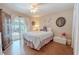 Cozy bedroom with a sliding door to an outdoor sitting area, wood floors, and closet at 465 Holly Hill Rd, Oldsmar, FL 34677