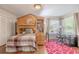Bright bedroom featuring a lofted bed with workspace and a view through large windows at 465 Holly Hill Rd, Oldsmar, FL 34677