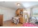 Bright bedroom featuring a lofted bed with workspace and a closet with white louvered doors at 465 Holly Hill Rd, Oldsmar, FL 34677