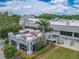 An exterior view of the Ardea Country Club's outdoor patio with dining tables, landscaping, and access stairs at 465 Holly Hill Rd, Oldsmar, FL 34677
