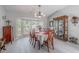 Dining room with a bay window, chandelier, and display cabinet at 465 Holly Hill Rd, Oldsmar, FL 34677