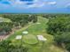 Aerial view of the lush green golf course at Ardea Country Club with a small pond to the left at 465 Holly Hill Rd, Oldsmar, FL 34677
