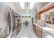 Galley kitchen with stainless steel appliances, ample cabinets, and skylights for natural light at 465 Holly Hill Rd, Oldsmar, FL 34677
