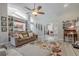 Bright living room with stylish decor, a ceiling fan, and an open view to the kitchen at 465 Holly Hill Rd, Oldsmar, FL 34677
