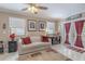 Cozy living room with tile floors, white couch, and access to the outdoor patio at 465 Holly Hill Rd, Oldsmar, FL 34677