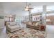 Spacious living room with built-in shelving, large windows, and a seamless flow to the dining area at 465 Holly Hill Rd, Oldsmar, FL 34677