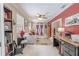 Sitting room with bright red accent wall, desk, and interior doors at 465 Holly Hill Rd, Oldsmar, FL 34677