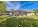 Expansive backyard with a screened-in pool area and ample green space, perfect for outdoor enjoyment and entertainment at 465 Holly Hill Rd, Oldsmar, FL 34677
