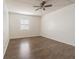 Comfortable bedroom with wood-look flooring, ceiling fan, and a window view at 4708 Michael Ct # 103, Tampa, FL 33614