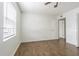 Cozy bedroom with wood-look floors and a window offering natural light at 4708 Michael Ct # 103, Tampa, FL 33614