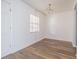 Dining room with wood-look floors, a modern light fixture, and a bright window at 4708 Michael Ct # 103, Tampa, FL 33614
