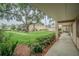 Exterior of a condo building with a courtyard view, featuring green grass and a walking path at 4708 Michael Ct # 103, Tampa, FL 33614