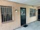 Charming front exterior showcasing unit's door and windows with decorative bars at 4708 Michael Ct # 103, Tampa, FL 33614
