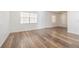 Spacious living room featuring hardwood floors, large windows, and plenty of natural light at 4708 Michael Ct # 103, Tampa, FL 33614