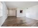 Bright living room featuring hardwood floors, neutral walls, and an open design to the kitchen at 4708 Michael Ct # 103, Tampa, FL 33614