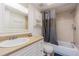 Cozy bathroom has a white sink, white cabinet, and a shower with a shower curtain at 4708 Michael Ct # 104, Tampa, FL 33614