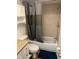 Tiled bathroom featuring a shower-tub combo, updated vanity, and storage cabinet for added convenience at 4708 Michael Ct # 104, Tampa, FL 33614