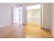 Bedroom with wood laminate floor features mirrored closet doors and an open doorway to another room at 4708 Michael Ct # 104, Tampa, FL 33614