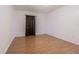 Bedroom featuring neutral walls, wooden floors, and a window with brown curtains at 4708 Michael Ct # 104, Tampa, FL 33614