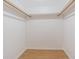 Walk-in closet with wood laminate floor and white walls, offering ample storage space at 4708 Michael Ct # 104, Tampa, FL 33614