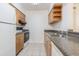 Functional kitchen features tile flooring, wood cabinets, and modern appliances at 4708 Michael Ct # 104, Tampa, FL 33614