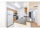 Kitchen with breakfast bar, oak cabinets, and modern white appliances at 4708 Michael Ct # 104, Tampa, FL 33614