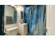 Compact bathroom featuring a vanity with sink, toilet and a shower with eye catching curtain at 4735 W Leila Ave, Tampa, FL 33616