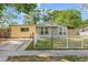 Charming single-story home with a fenced yard and driveway, showcasing its inviting curb appeal at 4735 W Leila Ave, Tampa, FL 33616