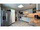 Bright kitchen featuring granite countertops, stainless steel refrigerator, and white appliances at 4735 W Leila Ave, Tampa, FL 33616