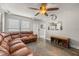 Bright living room with stylish flooring, ceiling fan, and pass-through window to the kitchen at 4735 W Leila Ave, Tampa, FL 33616