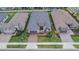 Aerial view of a home with tile roof, landscaped yard, and community setting at 4795 Freccia Loop, Wesley Chapel, FL 33543