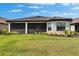 Expansive backyard with well-maintained landscaping, featuring a screened-in lanai for outdoor enjoyment at 4795 Freccia Loop, Wesley Chapel, FL 33543