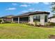 Well-maintained backyard showcasing the home's screened-in lanai and lush landscaping at 4795 Freccia Loop, Wesley Chapel, FL 33543
