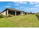 Lush green backyard with a screened-in lanai, offering a private outdoor retreat at 4795 Freccia Loop, Wesley Chapel, FL 33543