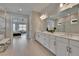 The bathroom has dual sinks, a vanity, and a shower, with the main bedroom visible beyond at 4795 Freccia Loop, Wesley Chapel, FL 33543