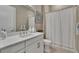 Bright bathroom with a shower, white vanity, and modern fixtures at 4795 Freccia Loop, Wesley Chapel, FL 33543