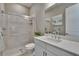 Modern bathroom featuring a glass-enclosed shower and sleek white vanity with marble countertop at 4795 Freccia Loop, Wesley Chapel, FL 33543