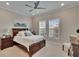 Comfortable bedroom featuring a wooden bed frame, neutral walls, and bright natural light at 4795 Freccia Loop, Wesley Chapel, FL 33543