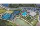 Overhead view of a community clubhouse, pool, tennis courts, and well-manicured green spaces at 4795 Freccia Loop, Wesley Chapel, FL 33543