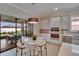 Kitchen dining area has a modern table, sliding doors to the lanai, and built-in oven at 4795 Freccia Loop, Wesley Chapel, FL 33543