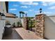 Cozy outdoor seating area with stone accents and a secure gated entrance at 4795 Freccia Loop, Wesley Chapel, FL 33543