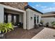 Inviting patio with brick flooring and comfortable seating near the front entrance at 4795 Freccia Loop, Wesley Chapel, FL 33543