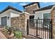 Inviting entrance features stone pillars, a secure gate, and a well-maintained brick path at 4795 Freccia Loop, Wesley Chapel, FL 33543