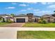 Charming single-Gathering home boasting stone accents, tile roof, manicured lawn, and brick driveway at 4795 Freccia Loop, Wesley Chapel, FL 33543