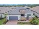 Beautiful home with a tile roof, stone accents, manicured landscaping, and a welcoming entrance at 4795 Freccia Loop, Wesley Chapel, FL 33543