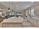 Gourmet kitchen featuring a large island, stainless steel appliances, and sliding glass doors to the outdoor area at 4795 Freccia Loop, Wesley Chapel, FL 33543