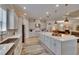Contemporary kitchen boasts stainless steel appliances, a large island, and views into other living spaces at 4795 Freccia Loop, Wesley Chapel, FL 33543