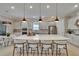 Spacious kitchen with large center island, pendant lighting, stainless appliances, and adjacent dining area at 4795 Freccia Loop, Wesley Chapel, FL 33543