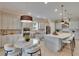 Open floor plan with a stylish kitchen featuring stainless appliances, and cozy breakfast nook with modern fixtures at 4795 Freccia Loop, Wesley Chapel, FL 33543